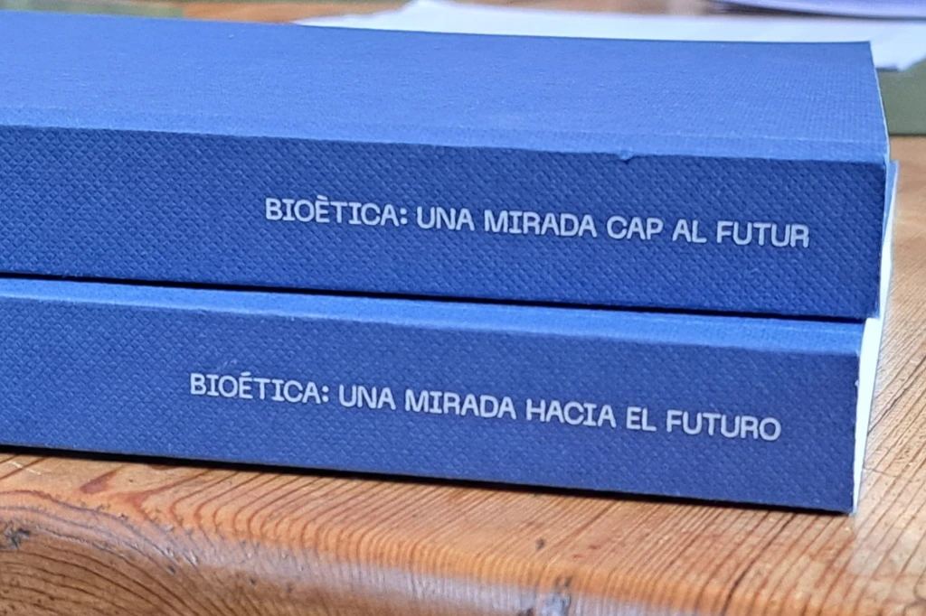 A photo of the spines of the Spanish and Catalan versions of the Grifols anniversary book.